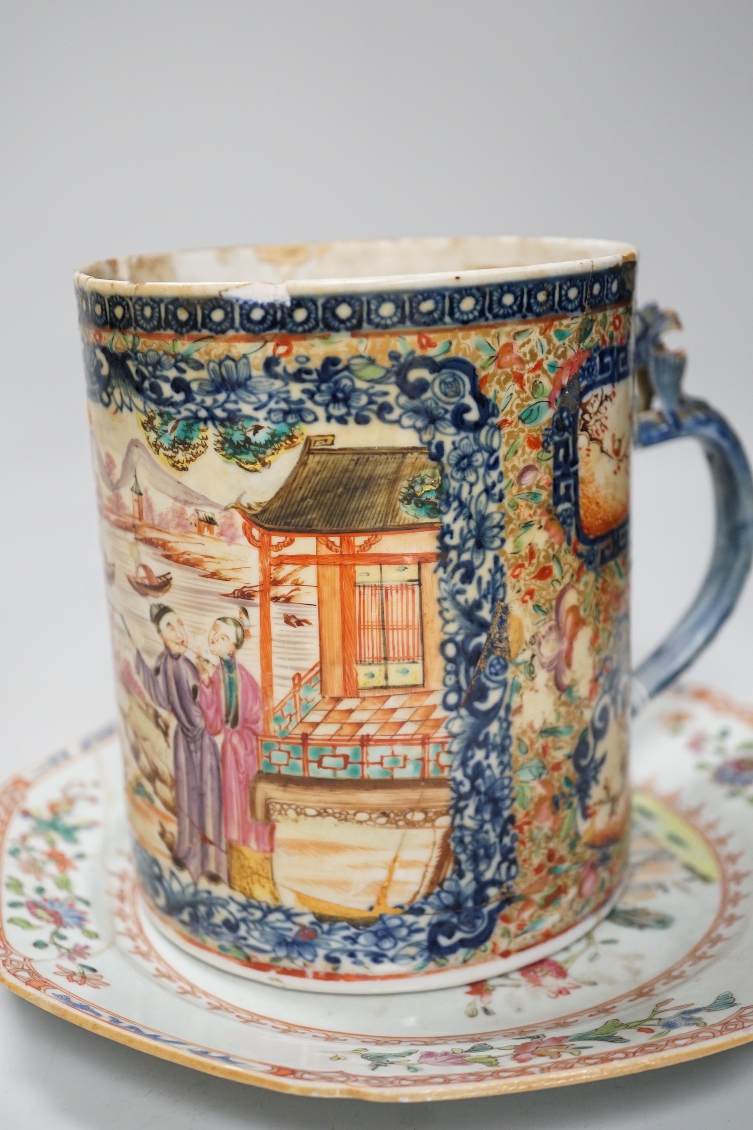 A Chinese figure of blanc de chine, a dragon tea bowl, a saucer, a large tankard, and another Chinese dish, tallest 23cm